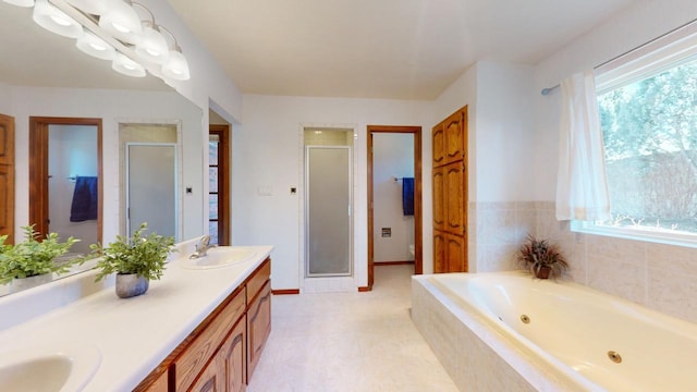 bathroom with a sink, baseboards, a shower stall, a whirlpool tub, and double vanity