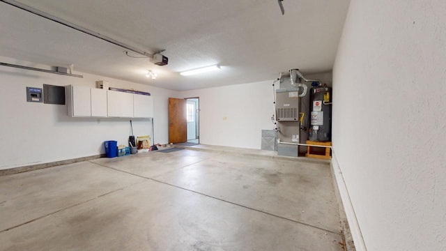 garage with heating unit, gas water heater, and a garage door opener