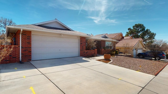 ranch-style home with an attached garage, concrete driveway, and brick siding