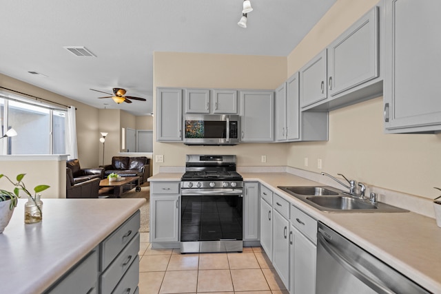 kitchen with light countertops, visible vents, gray cabinetry, appliances with stainless steel finishes, and a sink