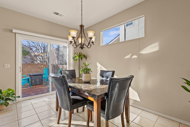 dining space featuring a chandelier, a wealth of natural light, visible vents, and light tile patterned floors