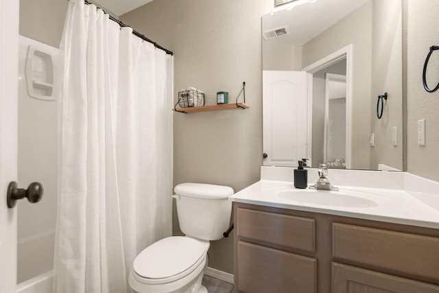 full bathroom featuring toilet, vanity, and visible vents