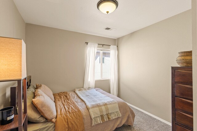 bedroom with carpet flooring, visible vents, and baseboards