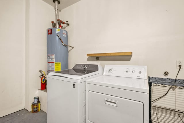 washroom featuring washing machine and dryer, laundry area, and water heater