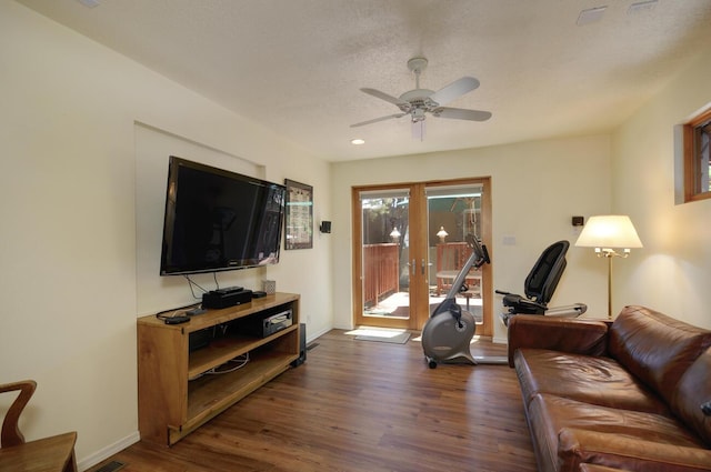 living room with baseboards, ceiling fan, dark wood-style flooring, a textured ceiling, and french doors