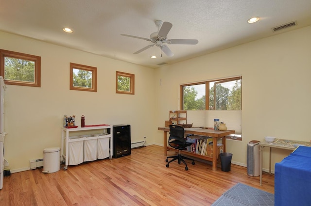 office area featuring light wood-type flooring, visible vents, baseboard heating, and recessed lighting