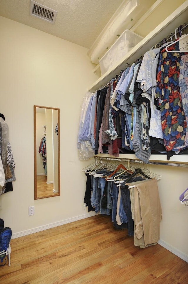 spacious closet with visible vents and wood finished floors