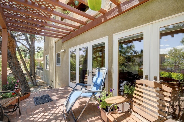 view of patio with french doors and a pergola