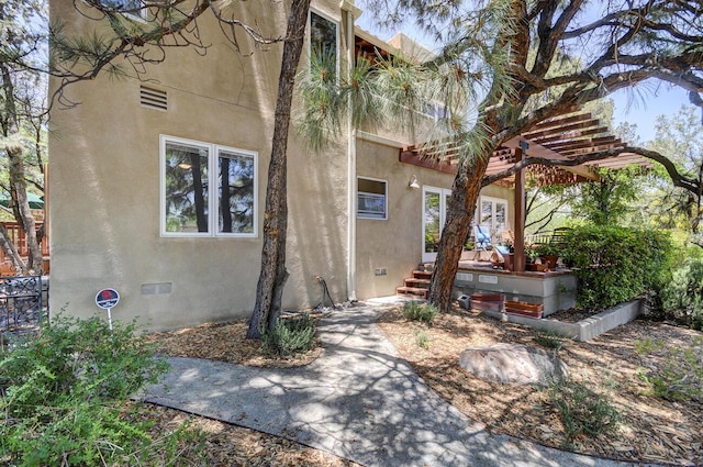 view of side of property featuring stucco siding