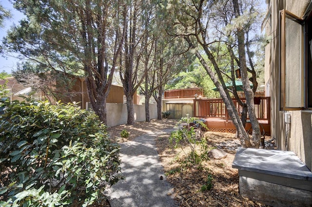 view of home's exterior with fence and a deck