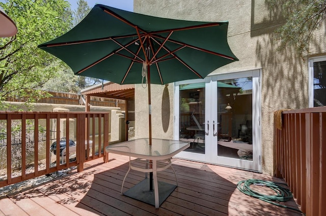 deck featuring french doors and fence