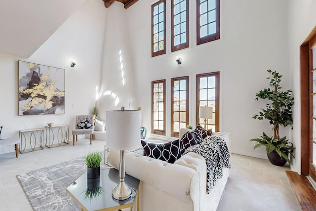 living room featuring a towering ceiling and tile patterned floors