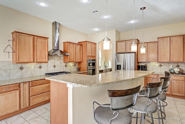 9316 Iron Creek Ln NW, Albuquerque, NM 87120 - kitchen with stainless steel appliances, wall chimney exhaust hood, a center island, tasteful backsplash, and a breakfast bar area