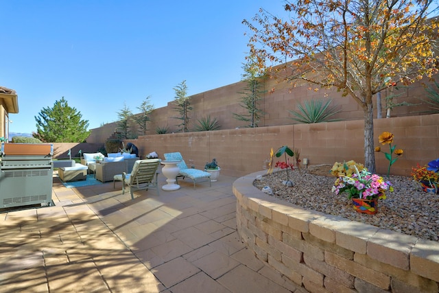 9316 Iron Creek Ln NW, Albuquerque, NM 87120 - fenced backyard with a patio area, a grill, and an outdoor living space