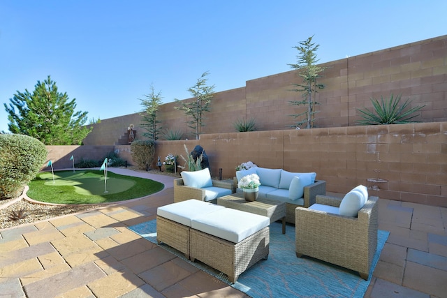 9316 Iron Creek Ln NW, Albuquerque, NM 87120 - fenced backyard featuring a putting area, a patio, and outdoor lounge area
