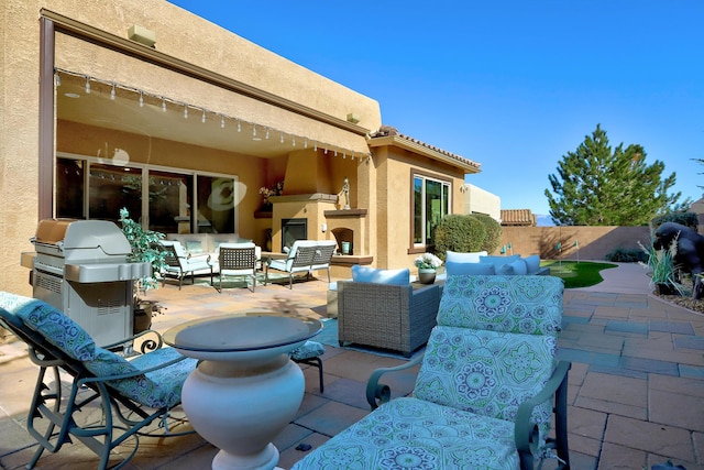 9316 Iron Creek Ln NW, Albuquerque, NM 87120 - view of patio / terrace featuring an outdoor living space with a fireplace and grilling area