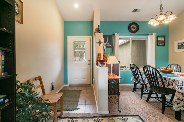 interior space with visible vents, a notable chandelier, and baseboards