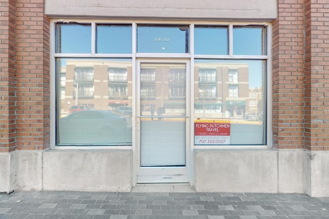 entrance to property with brick siding