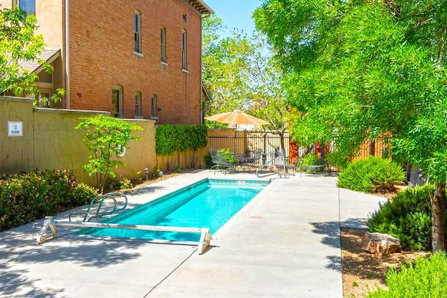 view of pool featuring a patio, a fenced backyard, and a fenced in pool