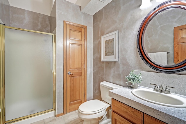 bathroom with toilet, a shower stall, tile patterned flooring, and vanity