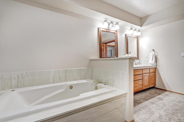 bathroom featuring vanity, baseboards, and a bath