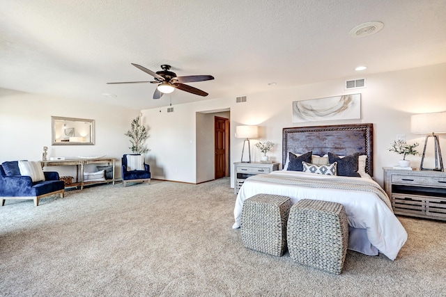 carpeted bedroom with a textured ceiling, ceiling fan, and visible vents