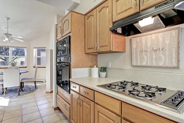 kitchen featuring light tile patterned flooring, under cabinet range hood, vaulted ceiling, light countertops, and black appliances