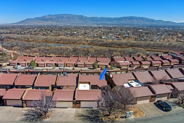 birds eye view of property with a mountain view and a residential view