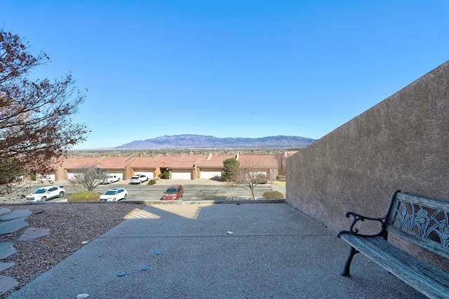 view of patio with a mountain view and fence