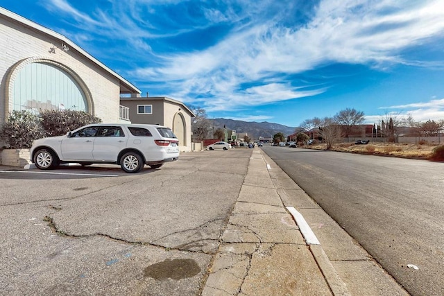 view of road with a mountain view and sidewalks