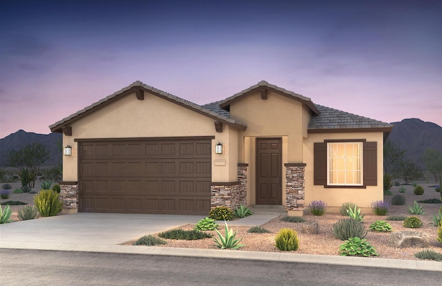 ranch-style house with driveway, stone siding, an attached garage, a mountain view, and stucco siding