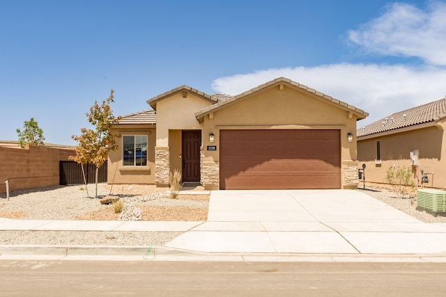 2178 Janet Way, Rio Rancho, NM 87144 - view of front of home with an attached garage, concrete driveway, stucco siding, and stone siding