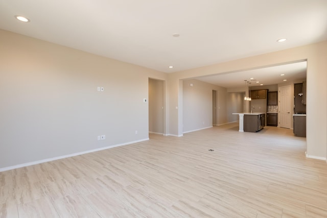 2178 Janet Way, Rio Rancho, NM 87144 - unfurnished living room featuring baseboards, recessed lighting, and light wood-style floors