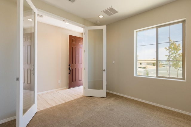 2178 Janet Way, Rio Rancho, NM 87144 - unfurnished bedroom featuring french doors, light carpet, multiple windows, recessed lighting, and baseboards