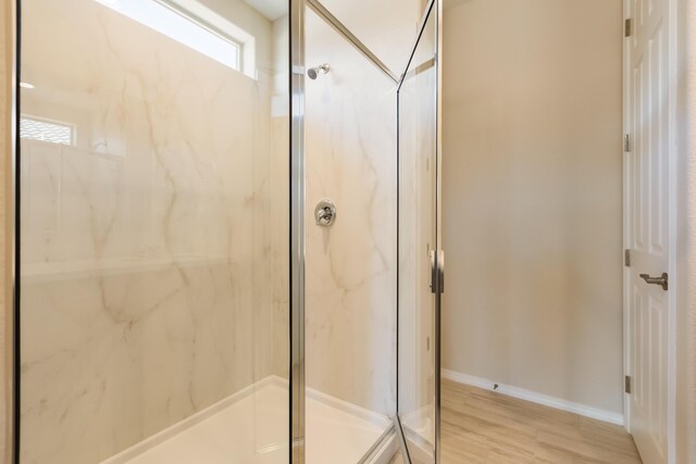 2178 Janet Way, Rio Rancho, NM 87144 - bathroom featuring a marble finish shower, wood finished floors, and baseboards