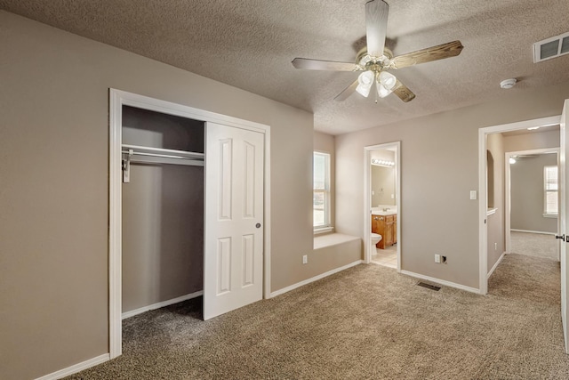 unfurnished bedroom featuring a closet, carpet flooring, visible vents, and baseboards