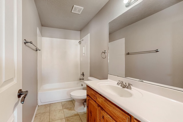 bathroom featuring toilet, washtub / shower combination, vanity, a textured ceiling, and tile patterned flooring