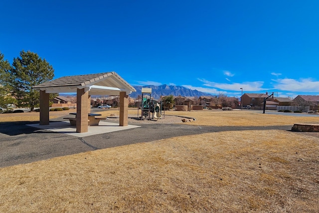 view of home's community featuring playground community and a mountain view