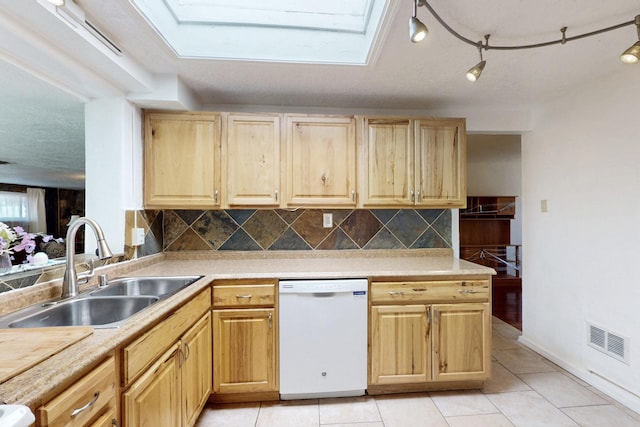 kitchen with visible vents, decorative backsplash, light brown cabinets, a sink, and dishwasher