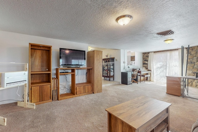 carpeted living room featuring visible vents and a textured ceiling