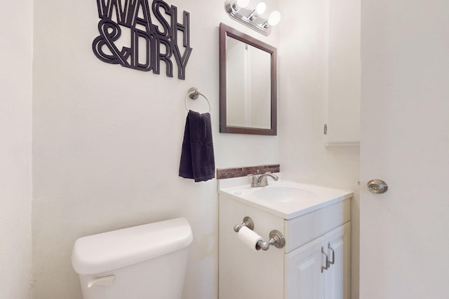 bathroom featuring toilet and vanity