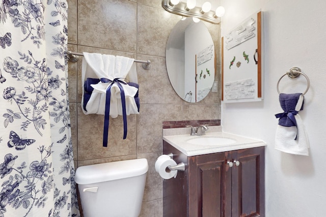 bathroom featuring tile walls, a shower with shower curtain, vanity, and toilet