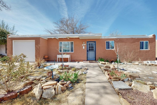 view of front facade featuring an attached garage and stucco siding