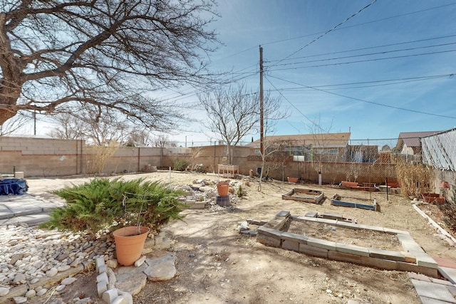 view of yard featuring a fenced backyard and a vegetable garden