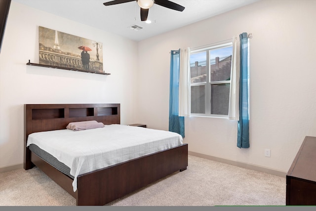 carpeted bedroom featuring visible vents, baseboards, and ceiling fan