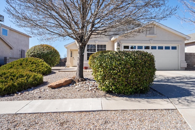 3230 Stony Meadows Cir NE, Rio Rancho, NM 87144 - view of front of home with an attached garage, stucco siding, and driveway