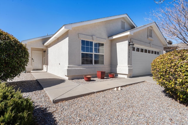 single story home with a garage and stucco siding