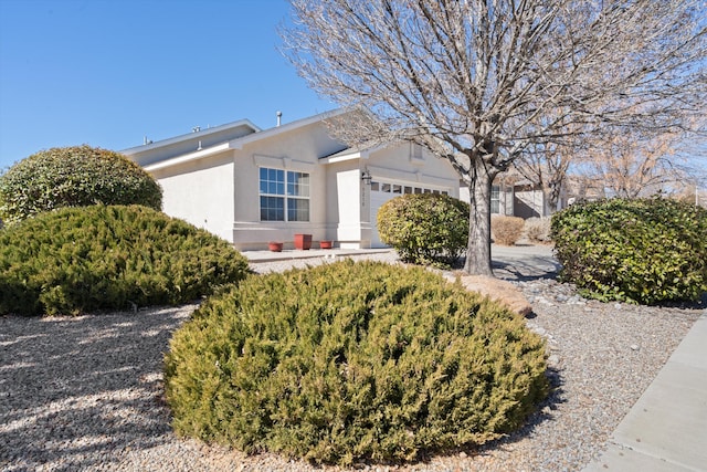 view of front of house featuring a garage and stucco siding