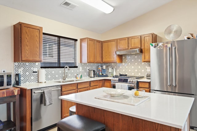 kitchen featuring a sink, visible vents, vaulted ceiling, light countertops, and appliances with stainless steel finishes