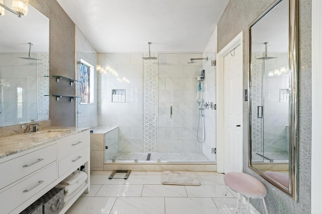 full bath with a stall shower and vanity